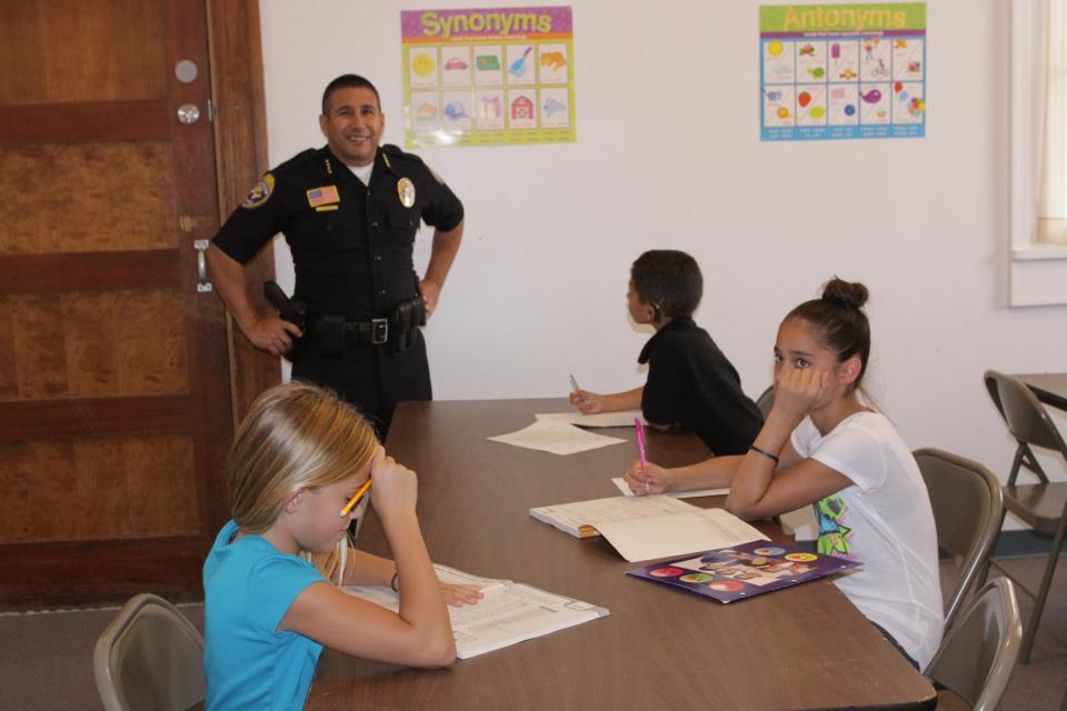 Chief Ramirez and PAL members doing homework